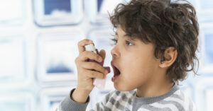 Child using asthma inhaler