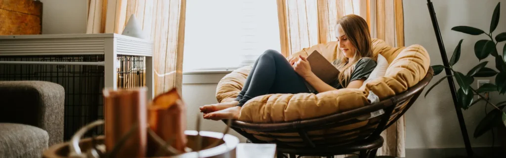 Woman reading at home after a pest infestation. Contact Twin Forks Pest Control® for your pest control and extermination needs in Eastern Long Island.